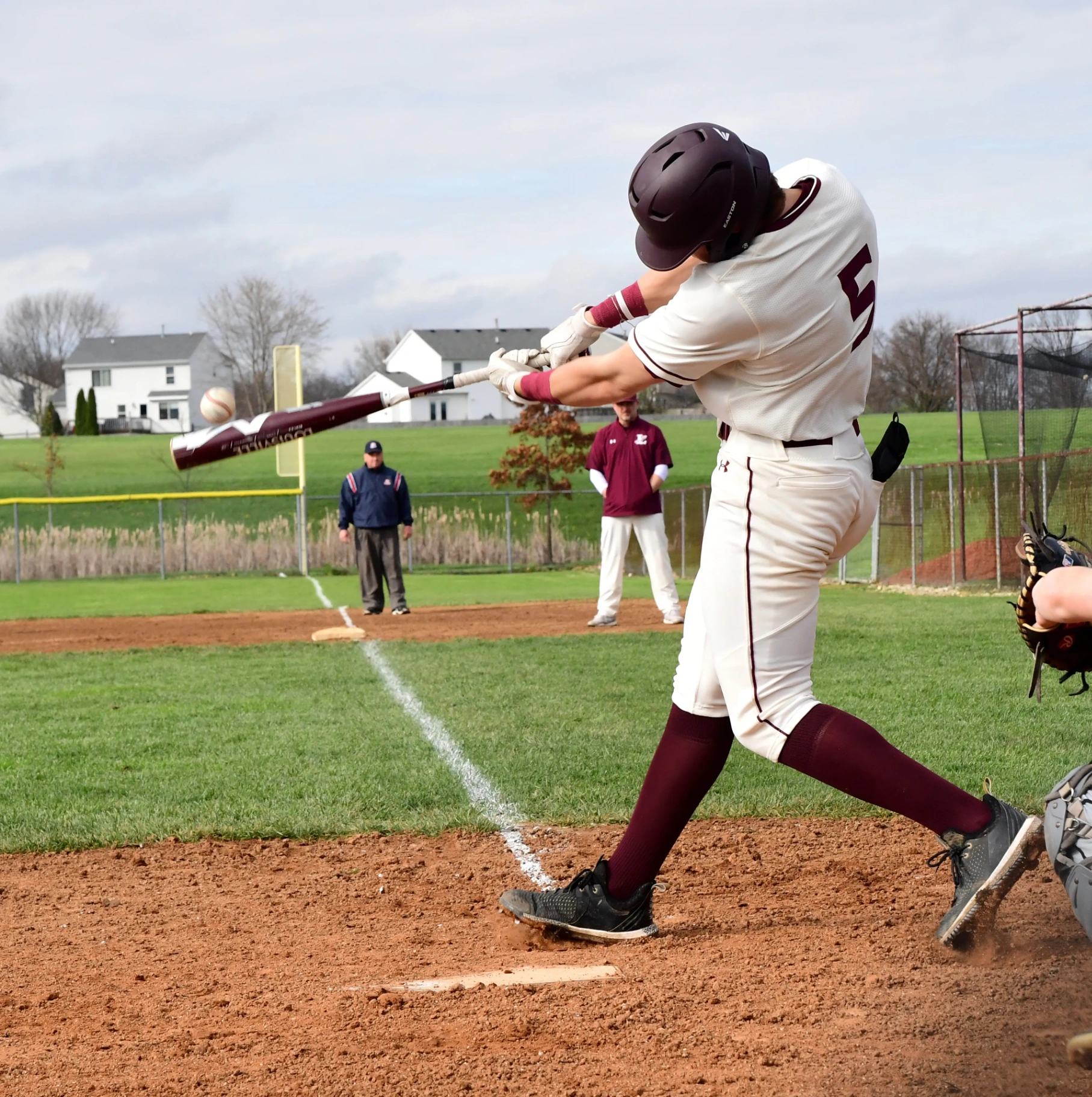 Baseball player at moment of contact in a premium indoor training facility